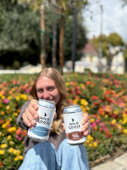 image of woman holding canned wild goose coffee drinks